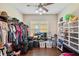 Spacious walk-in closet featuring ample hanging racks, shelving, and hardwood floors for convenient storage solutions at 11726 Belle Haven Dr, New Port Richey, FL 34654