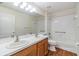 Bathroom featuring a double vanity, tub and shower combo, and wood flooring at 12027 Yellow Finch Ln, Trinity, FL 34655