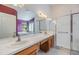 Bright bathroom with a double sink vanity, soaking tub, and walk-in shower at 12027 Yellow Finch Ln, Trinity, FL 34655