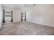 Spacious bedroom featuring neutral carpet, large windows, and ample natural light at 12027 Yellow Finch Ln, Trinity, FL 34655