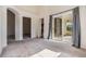 Bedroom featuring neutral carpet, access to patio and walk-in closet at 12027 Yellow Finch Ln, Trinity, FL 34655