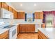 Kitchen boasts white appliances, laminate countertops, wood cabinets and natural lighting at 12027 Yellow Finch Ln, Trinity, FL 34655