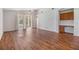 Open-concept living space featuring beautiful hardwood flooring, a ceiling fan, and a built-in desk at 12027 Yellow Finch Ln, Trinity, FL 34655
