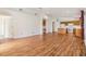 Expansive living room with hardwood floors, ample lighting, and seamless transition to the kitchen at 12027 Yellow Finch Ln, Trinity, FL 34655