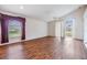 Bright living room with hardwood floors, ceiling fan and sliding glass door to the backyard at 12027 Yellow Finch Ln, Trinity, FL 34655