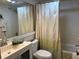 Bathroom view showcasing a shower with a modern vanity and shower curtain at 1243 S Martin Luther King Jr Ave # C505, Clearwater, FL 33756
