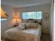 Comfortable bedroom with a decorative headboard, a large window and soft lighting at 1243 S Martin Luther King Jr Ave # C505, Clearwater, FL 33756