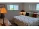Bedroom featuring a patterned bedspread, side lamps, and natural light from the window at 1243 S Martin Luther King Jr Ave # C505, Clearwater, FL 33756