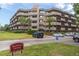 Multi-story condo complex with palm trees and well-maintained landscaping on a sunny day at 1243 S Martin Luther King Jr Ave # C505, Clearwater, FL 33756