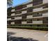 Exterior of building featuring private balconies and a meticulously landscaped yard at 1243 S Martin Luther King Jr Ave # C505, Clearwater, FL 33756
