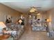 Cozy living room with floral sofas, tile floors, and a view into the dining area at 1243 S Martin Luther King Jr Ave # C505, Clearwater, FL 33756