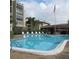 A large swimming pool with a row of lounge chairs and an American flag waving at 1243 S Martin Luther King Jr Ave # C505, Clearwater, FL 33756