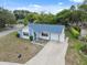 Aerial view of a cozy single-story home with a long driveway and well maintained lawn at 13001 Sawmill Way, Hudson, FL 34667