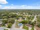 Neighborhood aerial view showcasing tree-lined streets and well-maintained homes and lawns at 13001 Sawmill Way, Hudson, FL 34667