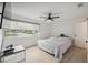 Bedroom featuring hardwood floors, neutral paint, and large window at 13001 Sawmill Way, Hudson, FL 34667