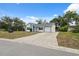 Charming single-story home featuring a private driveway, lush lawn, and traditional mailbox at 13001 Sawmill Way, Hudson, FL 34667