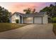 Charming single Gathering home with a well maintained front lawn and a private driveway at 13001 Sawmill Way, Hudson, FL 34667