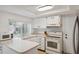 A bright kitchen offers generous counter space with a sink, and white cabinetry at 13001 Sawmill Way, Hudson, FL 34667