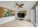 Bright living room featuring hardwood floors, neutral paint, large windows, and a ceiling fan at 13001 Sawmill Way, Hudson, FL 34667