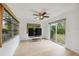 Bright living room featuring hardwood floors, neutral paint, large windows and sliding glass door at 13001 Sawmill Way, Hudson, FL 34667