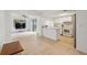 Open floor plan with kitchen access, sliding glass doors, and hardwood flooring at 13001 Sawmill Way, Hudson, FL 34667