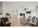 Spacious living room featuring light colored flooring, neutral paint, and plenty of natural light at 13001 Sawmill Way, Hudson, FL 34667