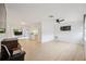 Spacious living room features light wood flooring and a ceiling fan at 13001 Sawmill Way, Hudson, FL 34667