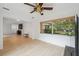 Spacious living room featuring hardwood floors, neutral paint, and large windows at 13001 Sawmill Way, Hudson, FL 34667