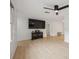 An open-concept living room is light and airy with a ceiling fan at 13001 Sawmill Way, Hudson, FL 34667