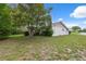 Manicured front yard featuring mature tree, green grass and view of the home's corner lot at 13001 Sawmill Way, Hudson, FL 34667