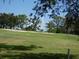View of an ample green backyard on a sunny day at 13010 Wedgewood Way # A, Hudson, FL 34667