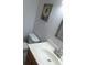 Bathroom with a simple vanity, mirror, and artwork on the wall at 13010 Wedgewood Way # A, Hudson, FL 34667