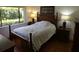 Comfortable bedroom with hardwood floors and ample natural light from the adjacent window at 13010 Wedgewood Way # A, Hudson, FL 34667