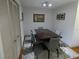 Dining room featuring a dark wood table with gray upholstered chairs and light fixture at 13010 Wedgewood Way # A, Hudson, FL 34667