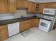 Spacious kitchen boasts matching appliances and granite countertops at 13010 Wedgewood Way # A, Hudson, FL 34667