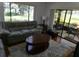 Inviting living room with a view of the outdoor patio, great natural light, and cozy furniture at 13010 Wedgewood Way # A, Hudson, FL 34667