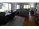 Convenient home office with desk setup, hardwood floors, and view into the living room at 13010 Wedgewood Way # A, Hudson, FL 34667