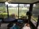 Enclosed patio with table and chairs offering views of the lush greenery and well-maintained grounds at 13010 Wedgewood Way # A, Hudson, FL 34667