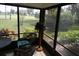 Relaxing screened porch featuring views of lush greenery and comfortable wicker furniture at 13010 Wedgewood Way # A, Hudson, FL 34667