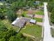 High aerial view of house, detached garage, large yard, surrounded by abundant trees at 13444 English Parrot Rd, Brooksville, FL 34614