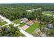 Aerial view of the property showcasing a house, detached garage, and extensive green space at 13444 English Parrot Rd, Brooksville, FL 34614