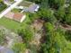 Aerial view showcasing home, detached garage, expansive yard, and lush greenery at 13444 English Parrot Rd, Brooksville, FL 34614