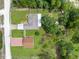 Aerial view of a home with a large backyard, firepit area, and mature trees offering privacy at 13444 English Parrot Rd, Brooksville, FL 34614
