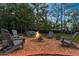 Inviting backyard fire pit area surrounded by Adirondack chairs, perfect for outdoor entertaining at 13444 English Parrot Rd, Brooksville, FL 34614