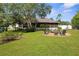 Beautiful backyard with well-maintained lawn and a cozy seating area with Adirondack chairs at 13444 English Parrot Rd, Brooksville, FL 34614