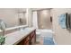 Bathroom with tub and shower, single sink vanity and tile flooring at 13444 English Parrot Rd, Brooksville, FL 34614
