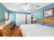 Bedroom with two closets, wooden floors, and blue walls at 13444 English Parrot Rd, Brooksville, FL 34614