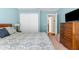 Cozy bedroom with blue accent wall, double closet, and dark wood dresser at 13444 English Parrot Rd, Brooksville, FL 34614