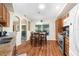 Charming dining area with hardwood floors, natural light, and a view of the enclosed patio at 13444 English Parrot Rd, Brooksville, FL 34614