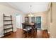 Inviting dining area with hardwood floors, chandelier lighting, and convenient access to the patio at 13444 English Parrot Rd, Brooksville, FL 34614